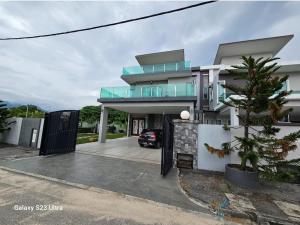 a house with a car parked in front of it at Luxurious Home Villa , Ipoh with Karaoke, Snooker for 15-20 pax in Ipoh