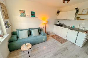 a living room with a couch and a kitchen at Little View in Liptovský Mikuláš