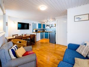 ein Wohnzimmer mit einem Sofa und einem Tisch sowie eine Küche in der Unterkunft Pass the Keys Lovely Old Fishermans Cottage in Anstruther