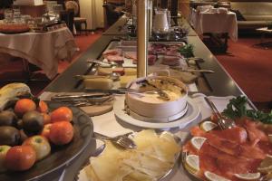 una línea de buffet con muchos tipos diferentes de comida en Hotel Metropol & Spa Zermatt, en Zermatt