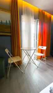 a room with two chairs and a table and a window at Boutique Hotel B Plus in Peje