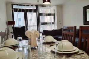 a dining room with a table with dishes on it at Entire Home in East London E3 near Bromley By Bow Station in London