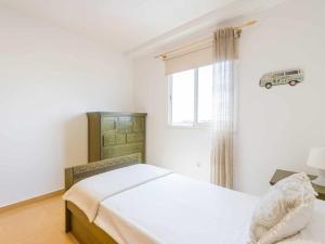 a bedroom with a bed and a window with a bus on the curtain at Mahostly Corralejo Vista Mar in Corralejo