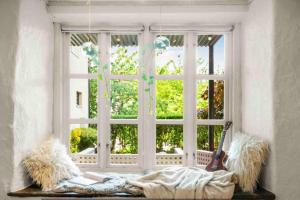 a woman laying on a blanket in front of a window at The old bakery in Sandviken in Bergen