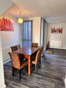 a dining room with a wooden table and chairs at Crystal Home in Manchester