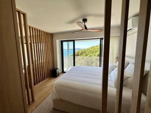 a bedroom with a bed with a view of the ocean at Suite de luxe avec vue mer in Sainte-Maxime