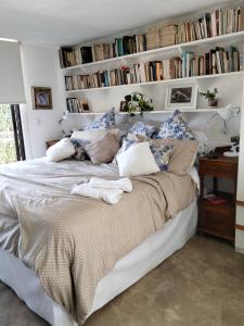 a bedroom with a large bed with bookshelves at Habitación con vista al lago in Valle de Bravo
