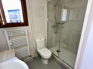 a bathroom with a toilet and a glass shower at Studio Villard-de-Lans, 1 pièce, 4 personnes - FR-1-515-179 in Villard-de-Lans