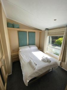 a bedroom with a bed with two towels on it at East kitcham lodge in Launceston