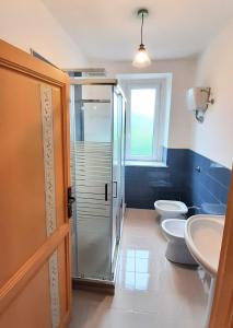 a bathroom with two toilets and a glass shower at Casale Battaglini in Castelnuovo Cilento +24 photos