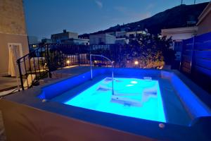 a swimming pool in the middle of a backyard at night at Grandma's House in Kalymnos