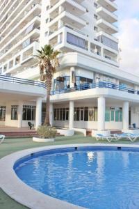 a large building with a swimming pool in front of a building at Estudio Paradise View - Playa Paraíso Tenerife in Adeje