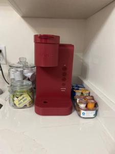 a red coffee maker sitting on top of a kitchen counter at The Grayson Home 3 bedroom 1 bath in New Albany