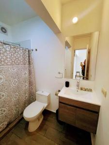 a bathroom with a toilet and a sink and a mirror at (T) Exclusivo departamento en Piura in Piura