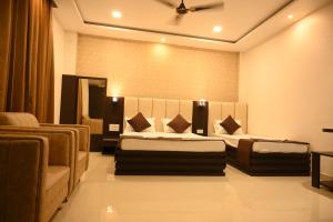 BishnāthHotel Tripti-Biswanath Chariali的有两张床和一张沙发的酒店房间