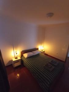 a bedroom with a bed with two lights on it at OCEANVIEW in Lajes das Flores