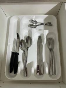 a drawer filled with silver utensils in a drawer at Apart Hotel Neri in Sinop