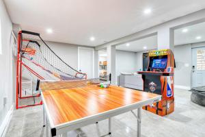 a ping pong table in a room with a game at PURE Enjoyment HOME with Game Room, Hot tub, Fire Pit in Long Pond