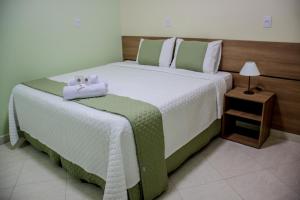 Ένα ή περισσότερα κρεβάτια σε δωμάτιο στο Domus Hotel Palmeiras - Canaã dos Carajás