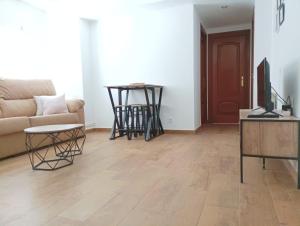 a living room with a couch and a table at Apto céntrico CASA CONCHA VUT 47-127 in Valladolid