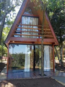 a tree house with a glass facade at Atma Anna in Piedade