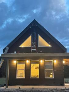 a house with a large window on the top of it at Sunrise Loft - Beach front guest house in Sandspit