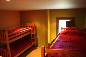 a bedroom with two bunk beds and a window at La Casa Nueva in Nieva de Cameros