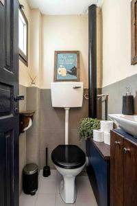 a bathroom with a black toilet and a sink at Luxury&Design apartments in Florentine in Tel Aviv