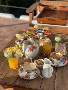 a table with a tea set on a wooden table at La Flor del Camino Posada in Tanti