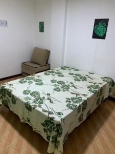 a bed and a chair in a room at APARTAMENTO PRAIA DO MORRO, 04 QUARTOS, ATE 10 PESSOAS. in Guarapari