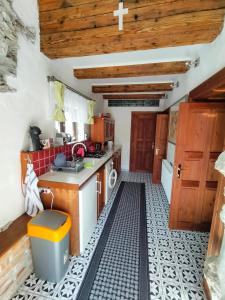 a kitchen with a black and white tiled floor at Paracelsus house in Banská Bystrica