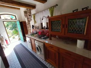 a kitchen with a stove and a washing machine at Paracelsus house in Banská Bystrica