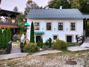 a white house with a black roof at Paracelsus house in Banská Bystrica