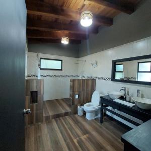 W łazience znajduje się toaleta, umywalka i lustro. w obiekcie Casa Valle Horus w mieście Valle de Bravo