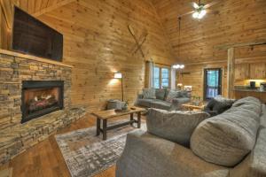 a living room with a couch and a fireplace at ESCAPE & ENJOY HAVEN - Cabin with Game Room & Hot Tub in Blue Ridge