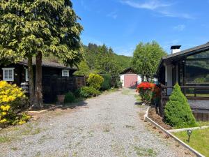 a gravel driveway in a yard next to a house at Spacieux chalet à Aywaille in Aywaille