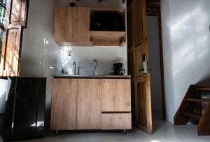 a kitchen with a sink and a black refrigerator at Casa Moore in Medellín +9 photos