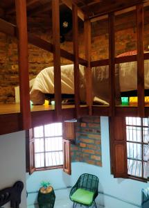 a room with a bunk bed and two chairs at Casa Moore in Medellín