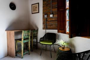 a room with two chairs and a desk and a table at Casa Moore in Medellín