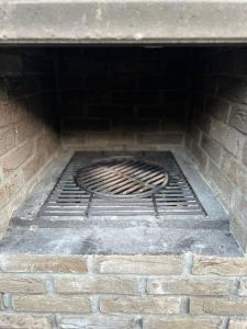 a brick oven with a metal grate in it at Spacieux chalet à Aywaille in Aywaille