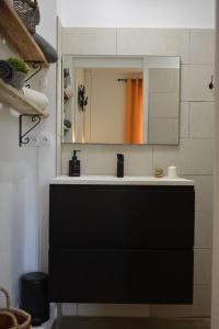 a bathroom with a black sink and a mirror at Villa ELISABETH in Aix-en-Provence
