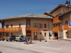 a large building with cars parked in a parking lot at Appartement Aussois, 3 pièces, 8 personnes - FR-1-508-55 in Aussois