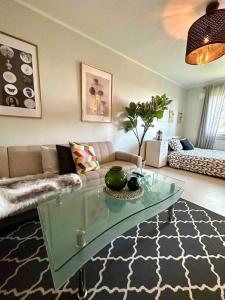 a living room with a couch and a glass table at Appartement on budget in oslo! in Oslo
