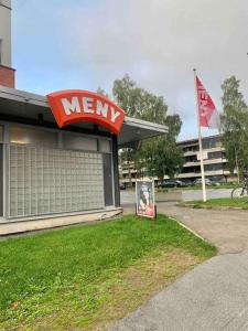 a mey store with a sign in the grass at Appartement on budget in oslo! in Oslo