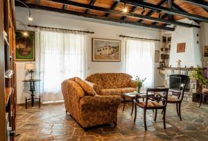 a living room with a couch and a table at Pontinos Villa in Myloi