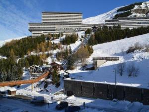 a large building on a snowy hill with snow covered ground at Studio Les Menuires, 1 pièce, 2 personnes - FR-1-452-221 in Les Menuires