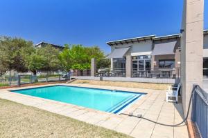 a swimming pool in front of a building at V&S Apartments - Luxury Studio in Fourways, Johannesburg in Sandton