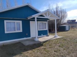 a blue house with a white door and windows at Cabañas deja vu in El Calafate