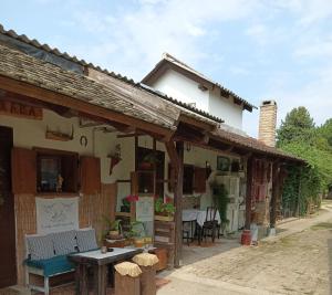 a building with a table in front of it at Apartments Bakine Čarolije in Karanac