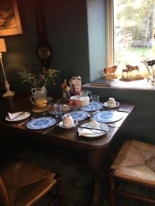 a wooden table with plates and teapots on it at Oscar Park Farm in York